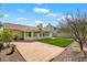The backyard features a covered patio, green lawn, mature trees, and a tiled patio for outdoor enjoyment at 4546 E Villa Rita Dr, Phoenix, AZ 85032