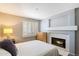 A bedroom with a fireplace, shuttered window, and neutral carpet at 4546 E Villa Rita Dr, Phoenix, AZ 85032