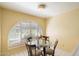 Dining area with glass table and chairs, complemented by an arched window at 4546 E Villa Rita Dr, Phoenix, AZ 85032
