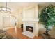 Living room showing fireplace with hearth, chandelier, and entry to home at 4546 E Villa Rita Dr, Phoenix, AZ 85032