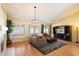 Bright living room featuring hardwood floors, a ceiling fan, and a large sectional sofa at 4546 E Villa Rita Dr, Phoenix, AZ 85032