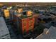 Expansive aerial view featuring modern building with lush gardens and city lights at 4808 N 24Th St # 303, Phoenix, AZ 85016