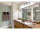 Bathroom with a double sink vanity, modern light fixtures, and plenty of counter space at 4808 N 24Th St # 303, Phoenix, AZ 85016