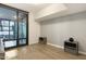 Empty living area with hardwood floors, natural lighting, and a patio at 4808 N 24Th St # 303, Phoenix, AZ 85016