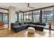 Inviting living room features a large sectional sofa, wooden floors, and floor-to-ceiling windows at 4808 N 24Th St # 303, Phoenix, AZ 85016