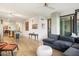 Open floor plan of living room, featuring a large sectional, modern lighting, and wood floors at 4808 N 24Th St # 303, Phoenix, AZ 85016