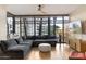 Bright living room with a large sectional, floor-to-ceiling windows, and a view of the city at 4808 N 24Th St # 303, Phoenix, AZ 85016