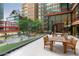Outdoor patio with dining table and chairs overlooking a fountain and trees at 4808 N 24Th St # 303, Phoenix, AZ 85016