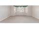 Neutral bedroom features a bay window, neutral paint and neutral carpeting at 4815 E Fernwood Ct, Cave Creek, AZ 85331