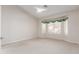 Neutral bedroom offers a vaulted ceiling, bay windows and neutral carpeting at 4815 E Fernwood Ct, Cave Creek, AZ 85331