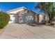 Home with three-car garage, concrete driveway, and tile roof at 4815 E Fernwood Ct, Cave Creek, AZ 85331