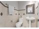 Cozy bathroom with tiled walls, a sleek toilet and sink, and modern fixtures for added convenience at 5811 W Irma Ln, Glendale, AZ 85308