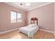 Charming bedroom with a quaint window view and a cozy bed, offering a peaceful retreat at 5811 W Irma Ln, Glendale, AZ 85308