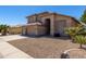 Attractive home featuring a three-car garage, desert landscaping, and a neutral color palette at 5811 W Irma Ln, Glendale, AZ 85308