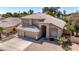 Aerial view of a beautiful two-story home with a three-car garage and a tile roof at 5811 W Irma Ln, Glendale, AZ 85308