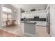 Contemporary kitchen features white cabinets, stainless steel appliances, and a functional center island at 5811 W Irma Ln, Glendale, AZ 85308