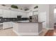 Modern kitchen with stainless steel appliances, white cabinetry, and granite countertops at 5811 W Irma Ln, Glendale, AZ 85308