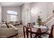 Bright living room featuring a large window, neutral furniture, and an elegant dining set at 5811 W Irma Ln, Glendale, AZ 85308