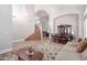 Spacious living area with a grand staircase, elegant dining set, and comfortable seating at 5811 W Irma Ln, Glendale, AZ 85308