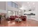 Bright, open living room with vaulted ceilings, modern furniture, and a seamless transition to the outdoors at 5811 W Irma Ln, Glendale, AZ 85308