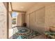 Covered patio features a patterned rug, sliding glass doors, and a view to the backyard at 5811 W Irma Ln, Glendale, AZ 85308