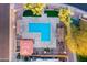 Aerial view of a community pool with lounge chairs and shaded pergolas at 7010 W Downspell Dr, Peoria, AZ 85345