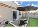 A cozy backyard featuring a patio lounge and artificial lawn, excellent for low-maintenance outdoor enjoyment at 7010 W Downspell Dr, Peoria, AZ 85345