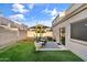 Private backyard with a well-maintained patio and a lush green lawn, perfect for relaxation at 7010 W Downspell Dr, Peoria, AZ 85345