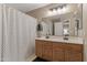 Bathroom with double sink vanity and a framed mirror at 7010 W Downspell Dr, Peoria, AZ 85345