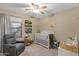 Cozy Bedroom with a crib, glider, and decorative accents at 7010 W Downspell Dr, Peoria, AZ 85345