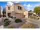 Charming home featuring a two-car garage, desert landscaping, and a neutral color palette at 7010 W Downspell Dr, Peoria, AZ 85345