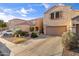 Charming two-story home featuring a two-car garage, desert landscaping, and a neutral color palette at 7010 W Downspell Dr, Peoria, AZ 85345
