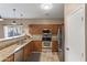 Well lit kitchen with granite countertops, stainless steel appliances, and a breakfast bar at 7010 W Downspell Dr, Peoria, AZ 85345