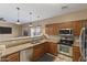 Modern kitchen with stainless steel appliances, granite countertops, and a breakfast bar at 7010 W Downspell Dr, Peoria, AZ 85345