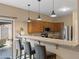 Modern kitchen with stainless steel appliances, granite countertops, and counter with barstool seating at 7010 W Downspell Dr, Peoria, AZ 85345