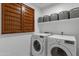 Well-organized laundry room featuring an LG washer and dryer with upper shelf and basket storage at 7010 W Downspell Dr, Peoria, AZ 85345