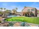 The backyard boasts a pool, putting green, bar area, and landscaping, perfect for outdoor living at 721 W Mountain Sky Ave, Phoenix, AZ 85045