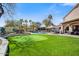 Backyard featuring a pool, putting green, lounge chairs, and a bar area for outdoor enjoyment at 721 W Mountain Sky Ave, Phoenix, AZ 85045