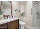 Bathroom featuring a wood vanity with a white countertop, white toilet, and a shower with glass doors at 721 W Mountain Sky Ave, Phoenix, AZ 85045