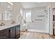 Modern bathroom with a spacious walk-in shower featuring sleek fixtures, and a vanity with black cabinets at 721 W Mountain Sky Ave, Phoenix, AZ 85045