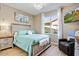 Cozy bedroom featuring wood-look floors, white trim, and a comfortable bed with soft blue bedding at 721 W Mountain Sky Ave, Phoenix, AZ 85045