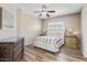 Comfortable bedroom with wood floors, a ceiling fan, a dresser, and a nicely made bed with neutral bedding at 721 W Mountain Sky Ave, Phoenix, AZ 85045