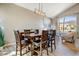 Elegant dining room with wood table, chairs, and modern chandelier at 721 W Mountain Sky Ave, Phoenix, AZ 85045