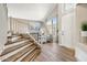 Inviting entryway with wood floors, staircase, and a large arched window at 721 W Mountain Sky Ave, Phoenix, AZ 85045