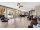 Bright living room with wood floors and large windows viewing the backyard and pool at 721 W Mountain Sky Ave, Phoenix, AZ 85045