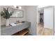 Modern bathroom with floating sink, wood shelf, sleek mirror, and stylish lighting at 7520 E Valley View Rd, Scottsdale, AZ 85250