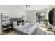 Bright bedroom featuring a large window, modern decor, and a comfortable bed with stylish pillows and throw blanket at 7520 E Valley View Rd, Scottsdale, AZ 85250
