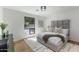 Bright bedroom with a plush bed, soft rug, and a large window offering a view of the outdoors at 7520 E Valley View Rd, Scottsdale, AZ 85250