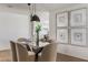 Stylish dining area featuring a glass table, plush chairs, modern lighting, and decorative artwork at 7520 E Valley View Rd, Scottsdale, AZ 85250
