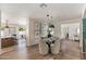 Elegant dining room with glass-top table, upholstered chairs, wood floors, and decorative wall art at 7520 E Valley View Rd, Scottsdale, AZ 85250